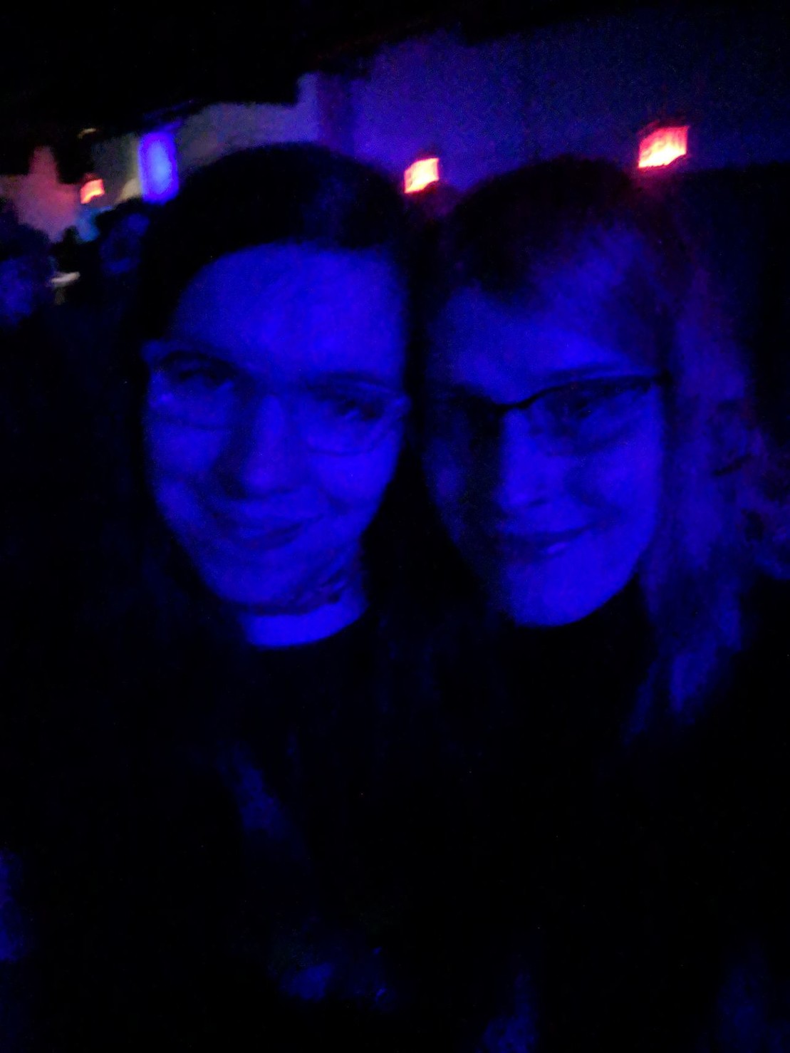 selfie of @caravel and I, lit by dim blue light
