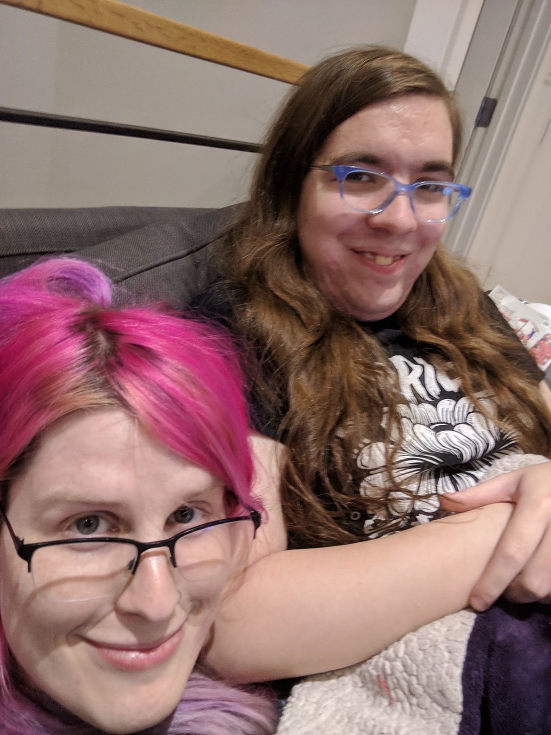 me and caravel sitting on a couch, smiling at the camera