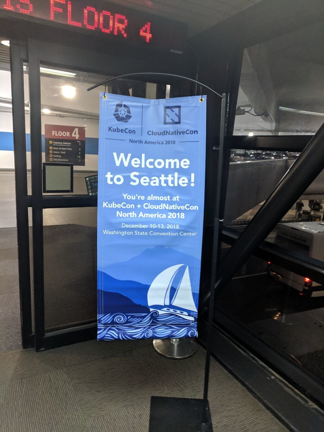 an airport sign welcoming me to Kubecon