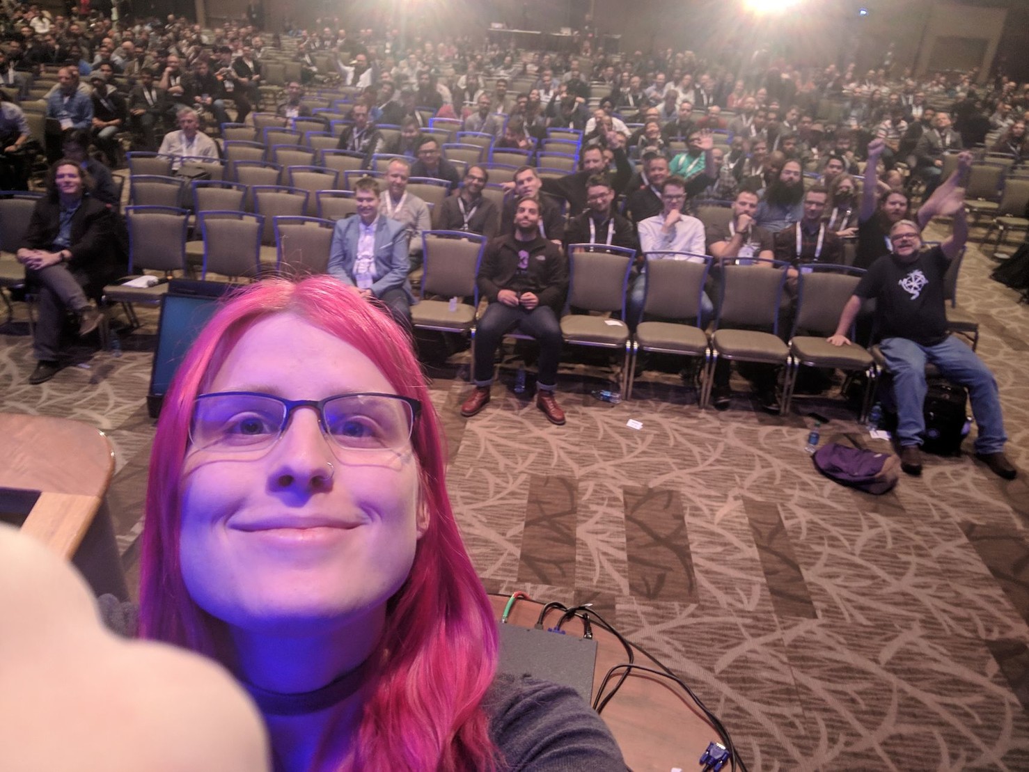 me taking a selfie in front of a big auditorium filled with people