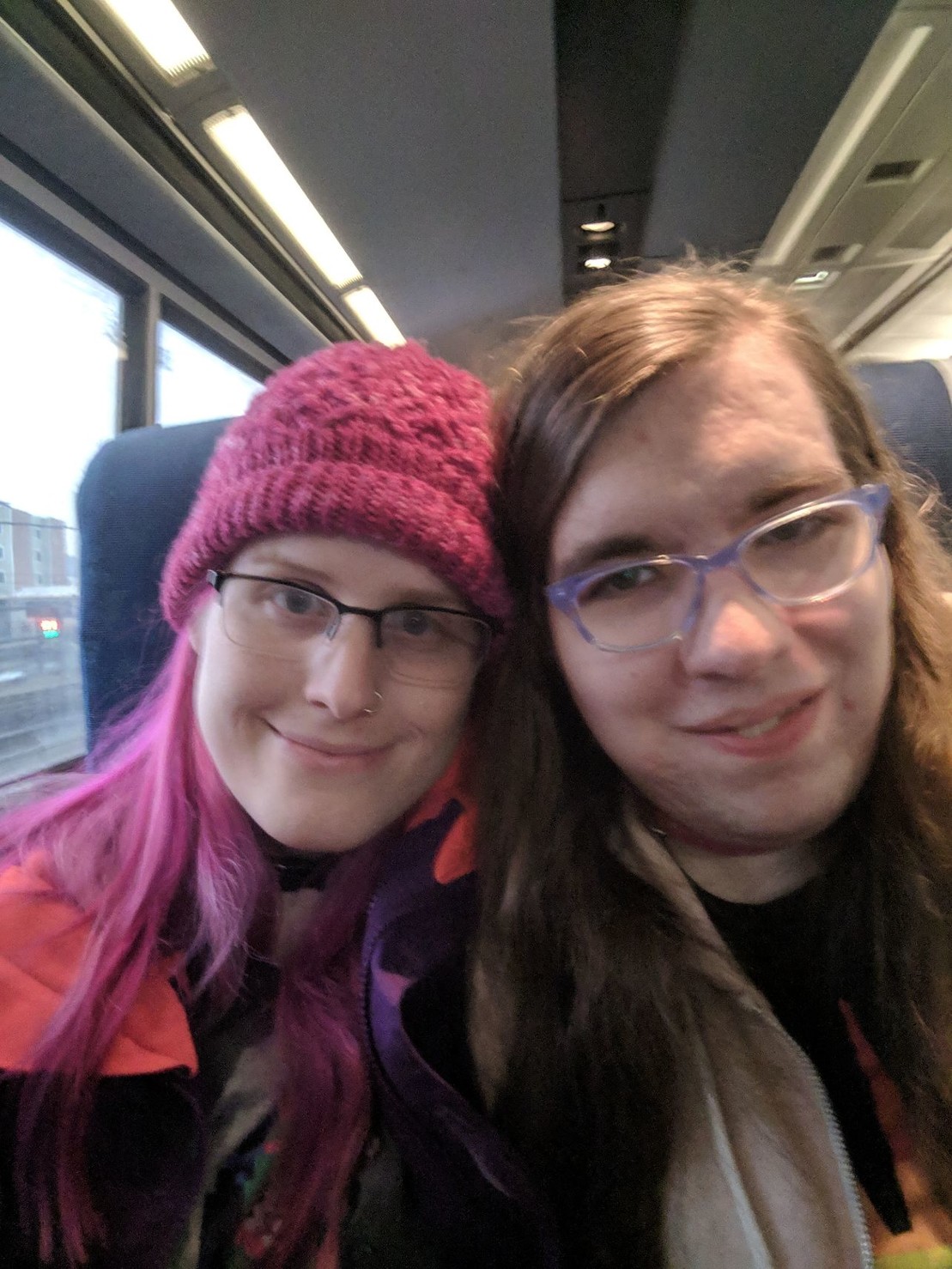 me and Natalie smiling at the camera on a train