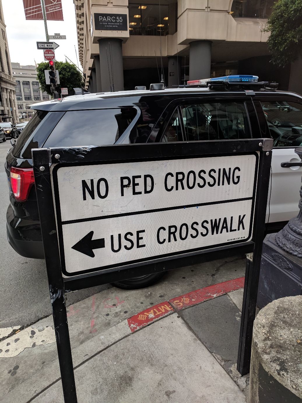 NO PED CROSSING / USE CROSSWALK