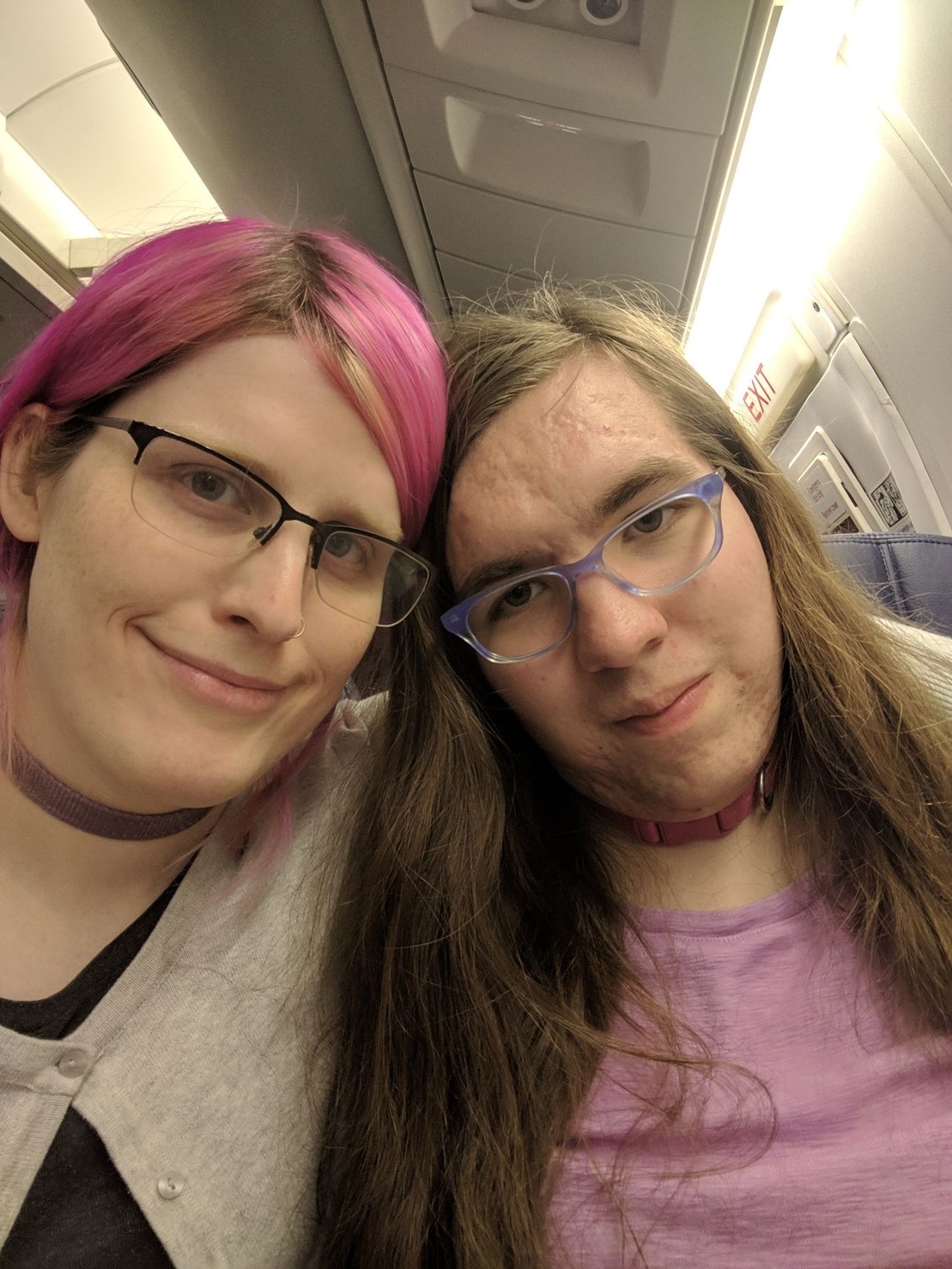 two very tired women on an aircraft