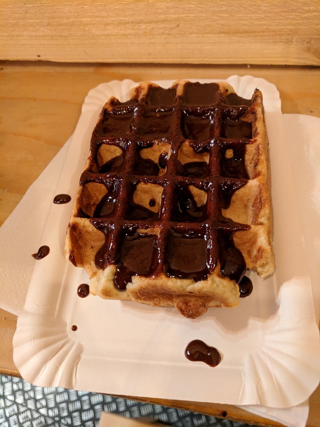 a square Belgian waffle covered in melted hocolate