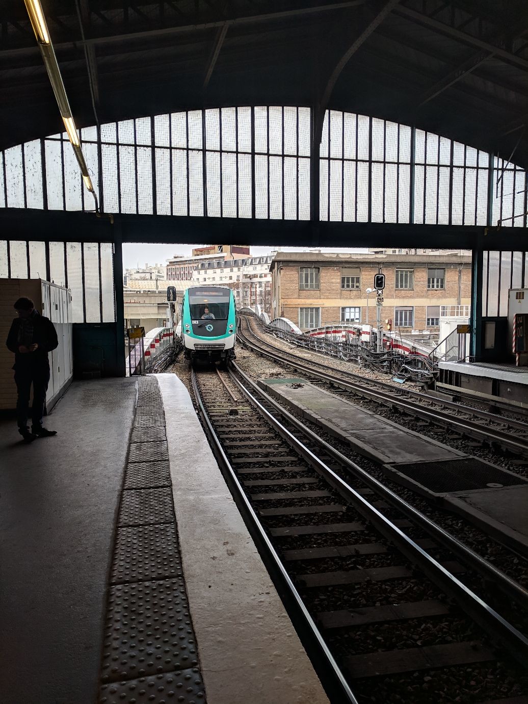 a metro train entering an elevated station