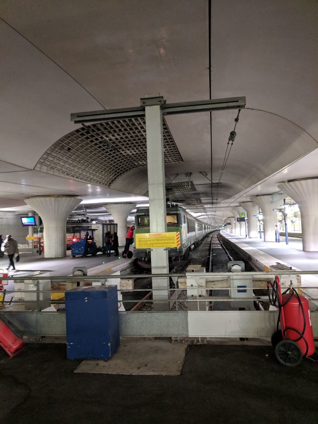 a sad 70s-era train located below a low concrete ceiling