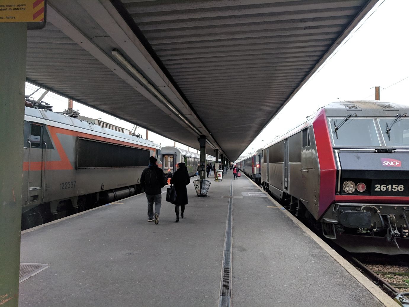 a few old style train coaches waiting at open air platforms