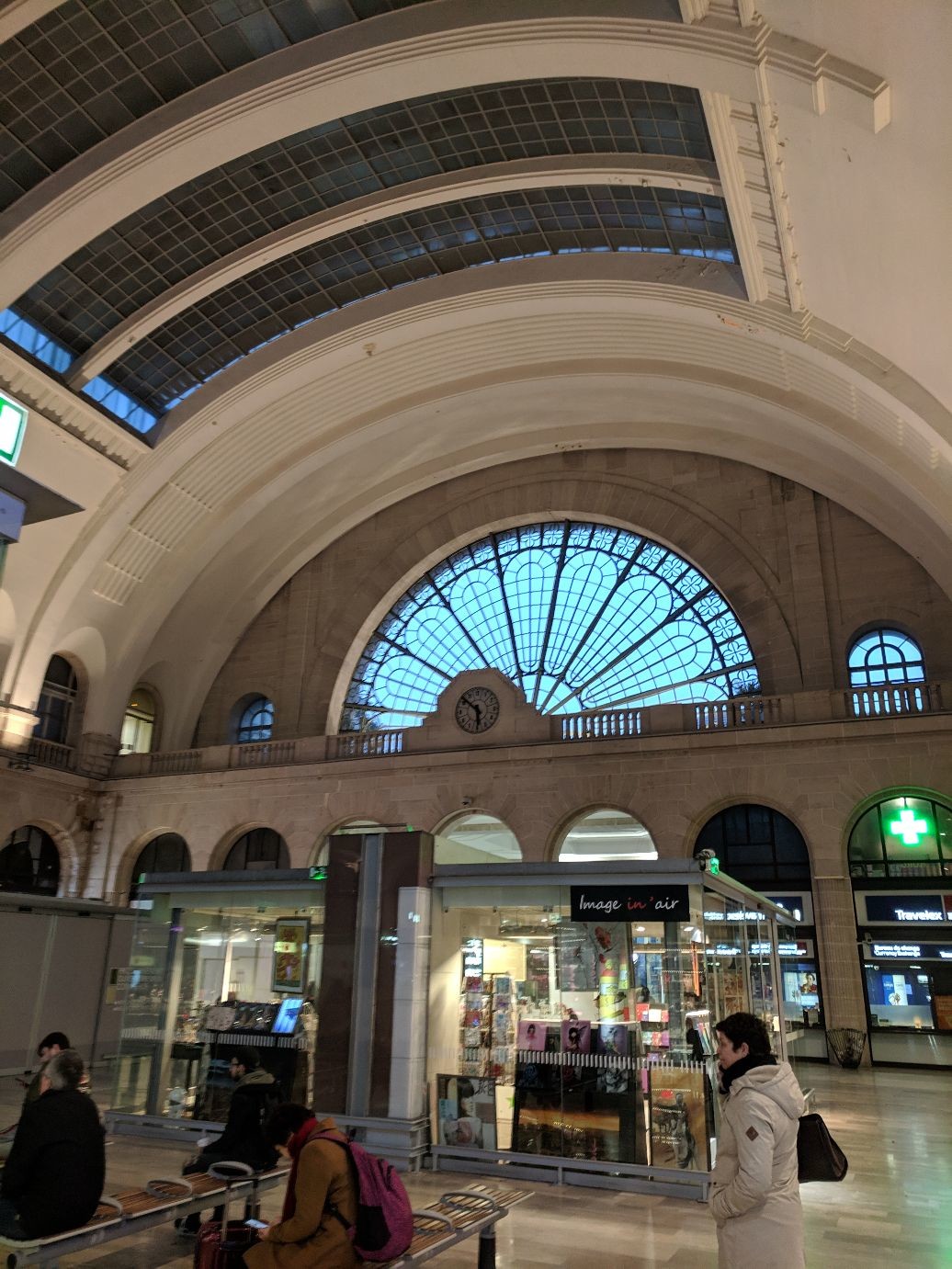 the same large arched peacock window seem from inside, set against a large arched ceiling