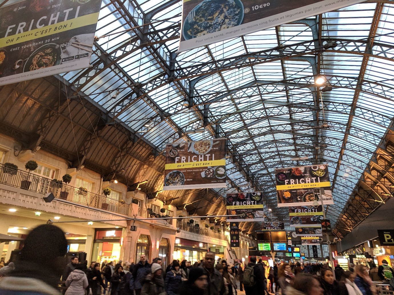 an arched glass and steel train shed roof, again marred by advertising.