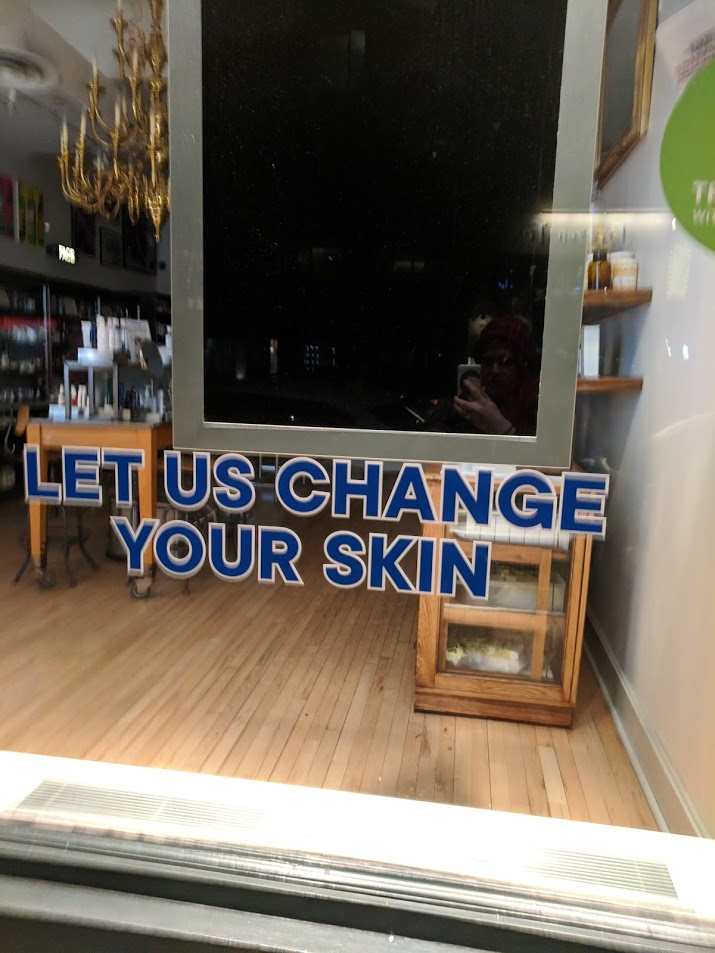 a sign saying LET US CHANGE YOUR SKIN