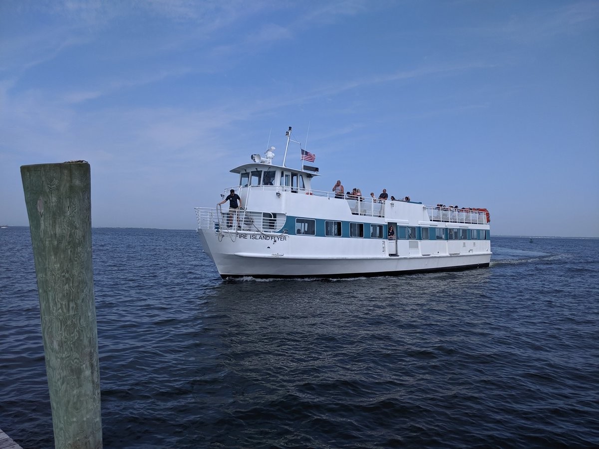 A ferry named Fire Island Flyer pulling into a dock