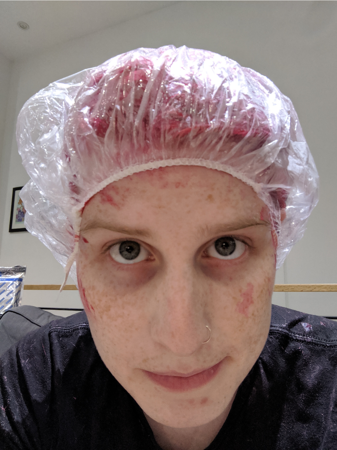 a girl with pink hair, and pink dye all over her face