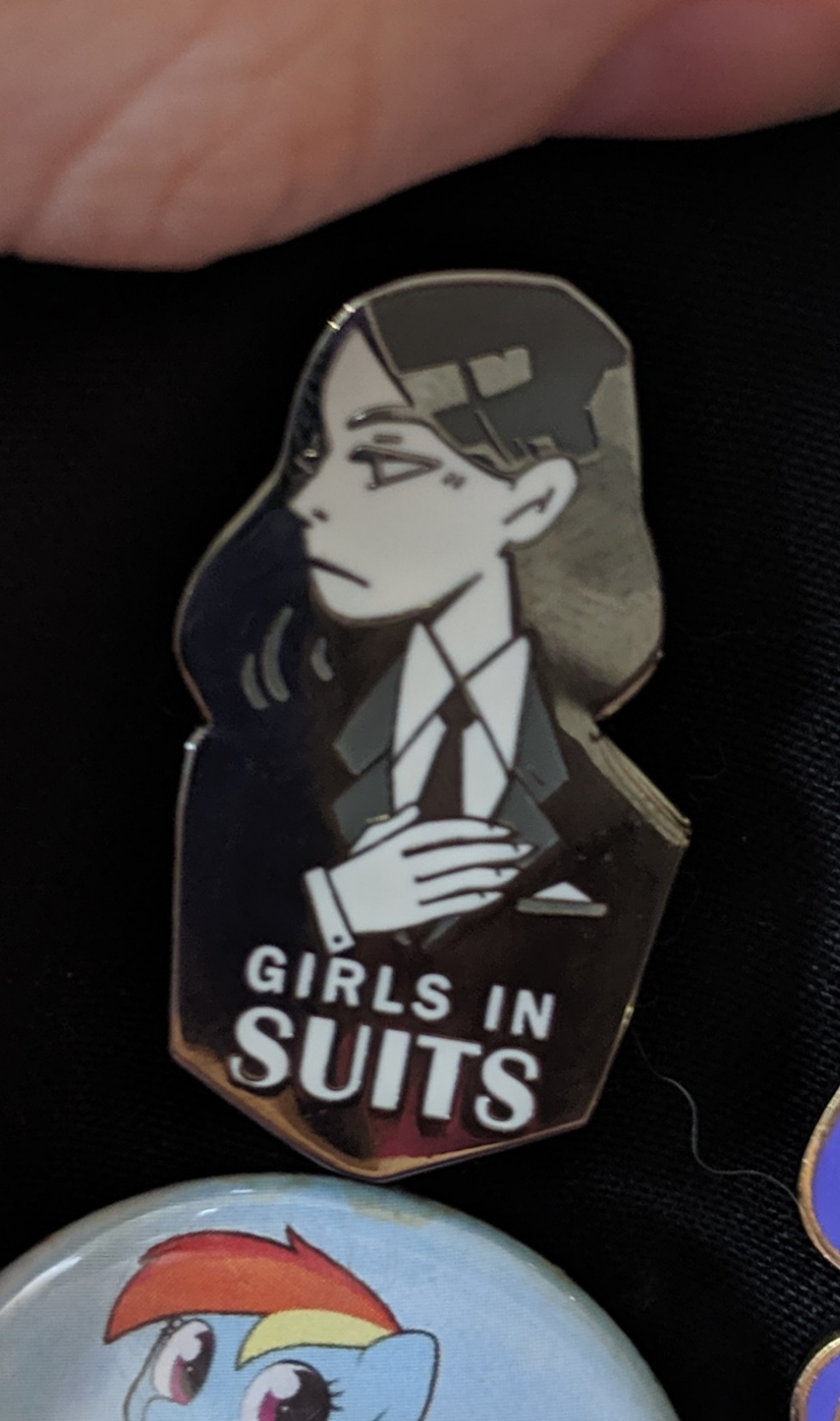  
a dapper girl pin labeled GIRLS IN SUITS