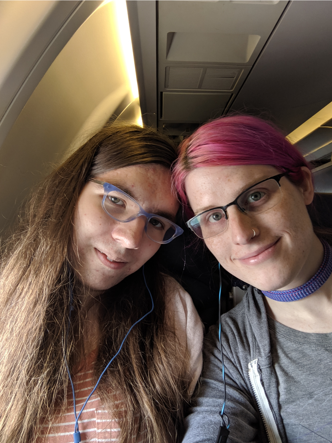 Natalie and I smiling on an airplane