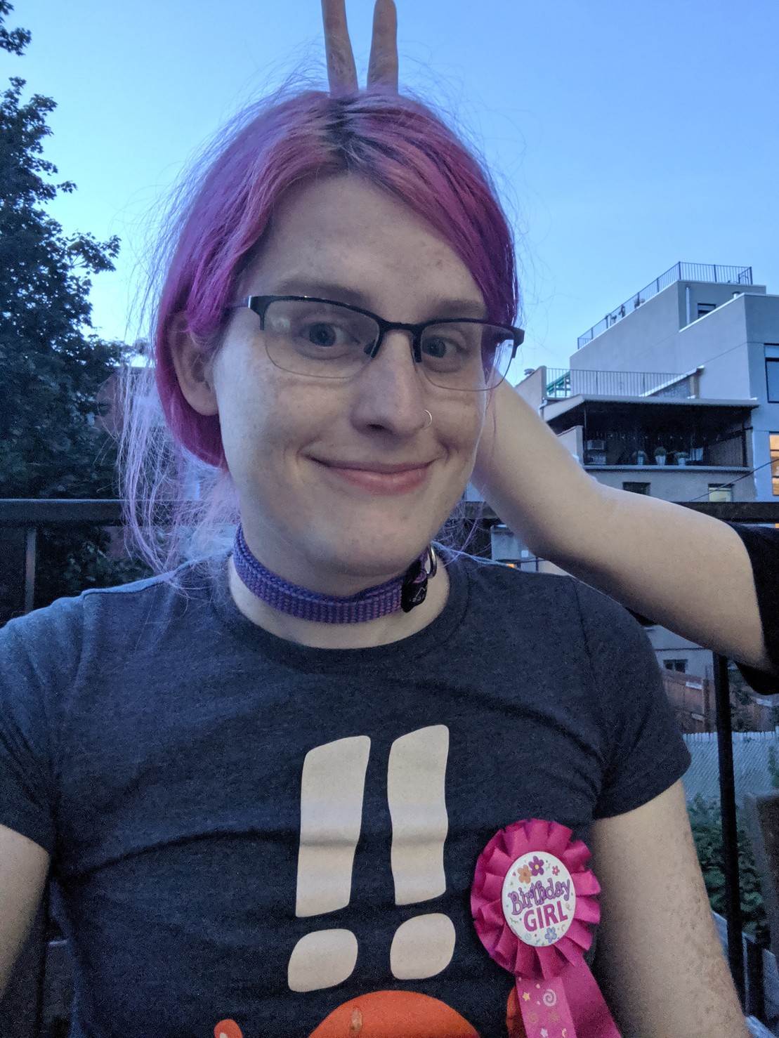 me wearing a birthday girl ribbon. Natalie is making bunny ears