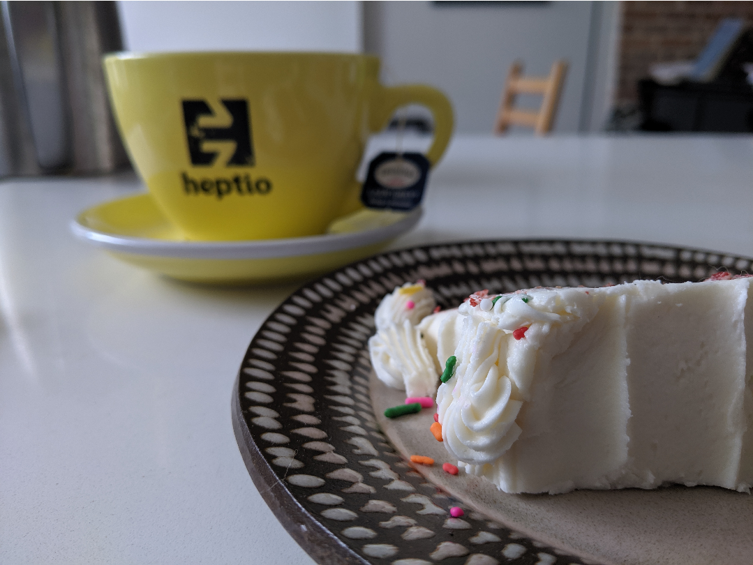 a slice of cake in the foreground, a mug of tea in the background