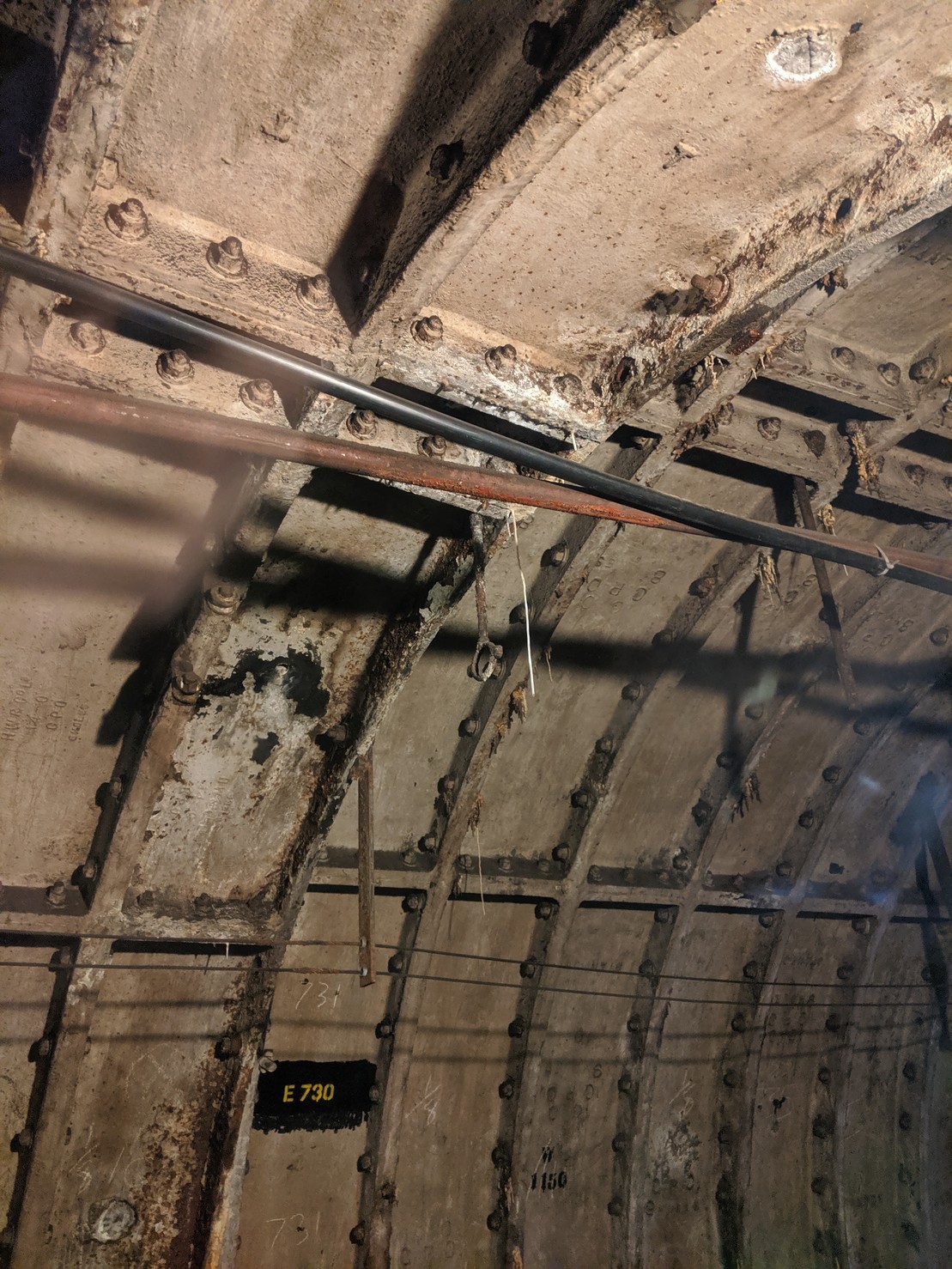 the interior of the mail rail tunnels, with cast iron walls and mineral stalactites