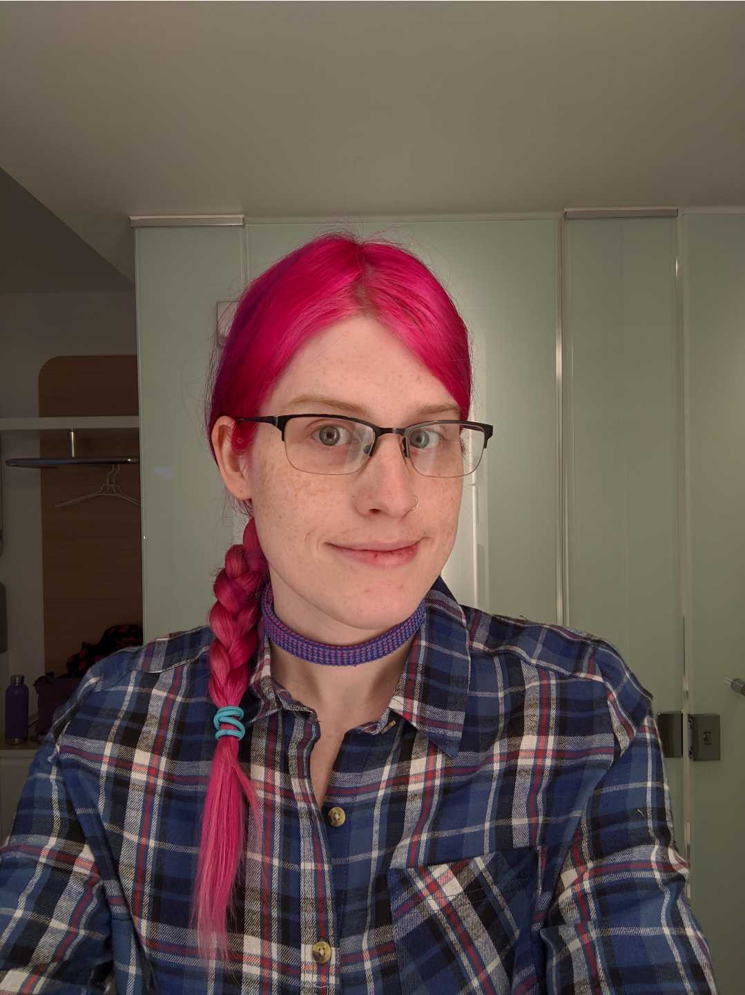 a selfie of me, with a braid and a plaid shirt