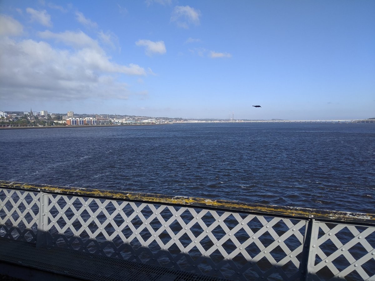Another view off a bridge to a large ocean and distant town