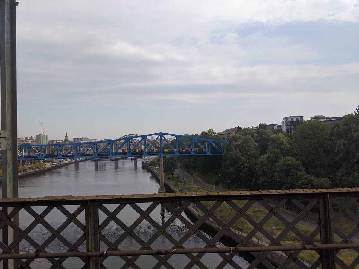 A view off a bridge at a rapid transit vehicle crossing an adjacent bridge