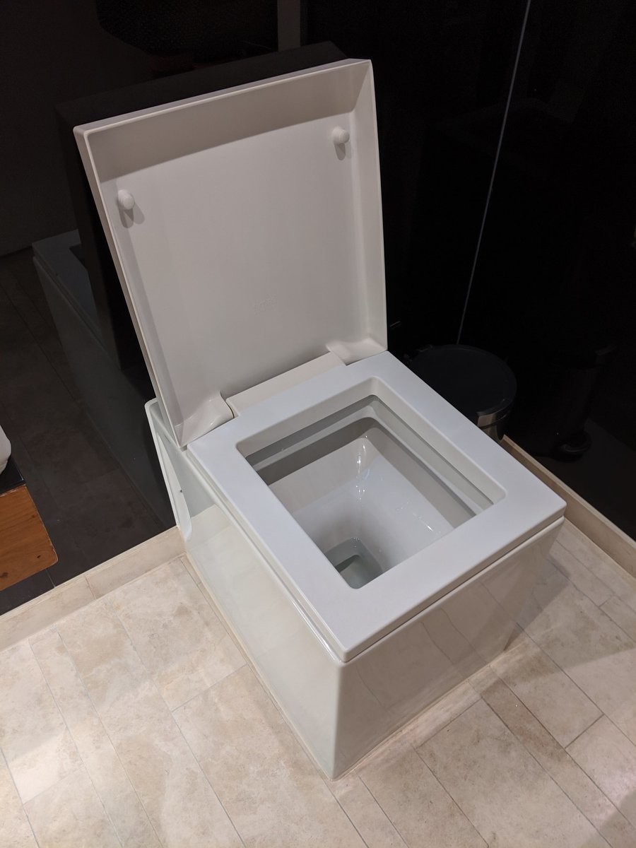 A very square toilet with a cube basin