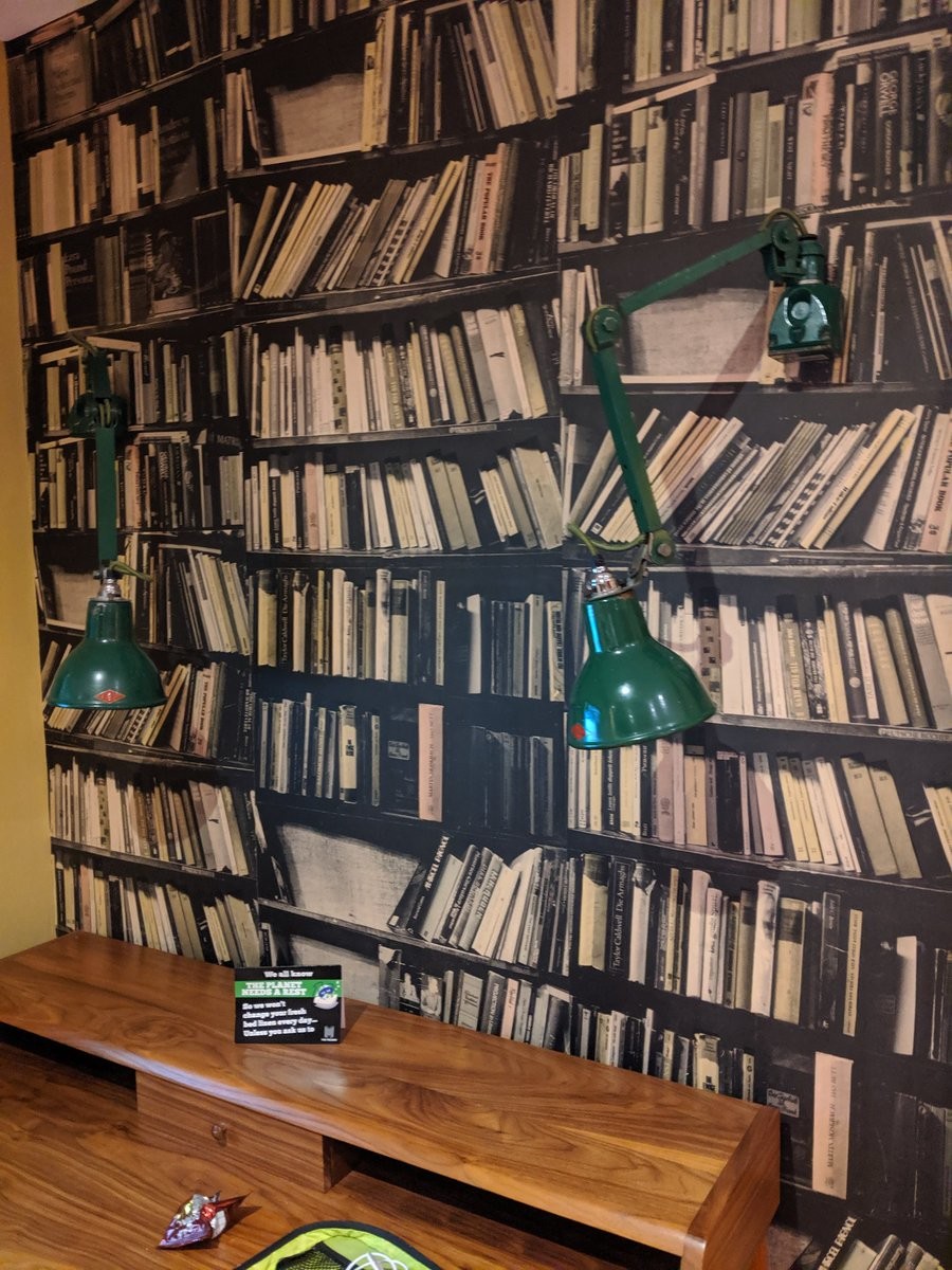 Wallpaper with graphics of messy  shelves of books