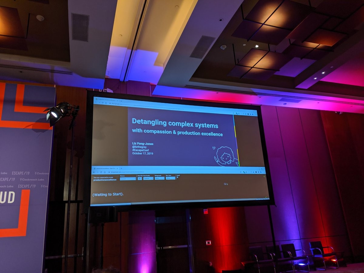 A slide deck, with closed captions below it on a projector screen