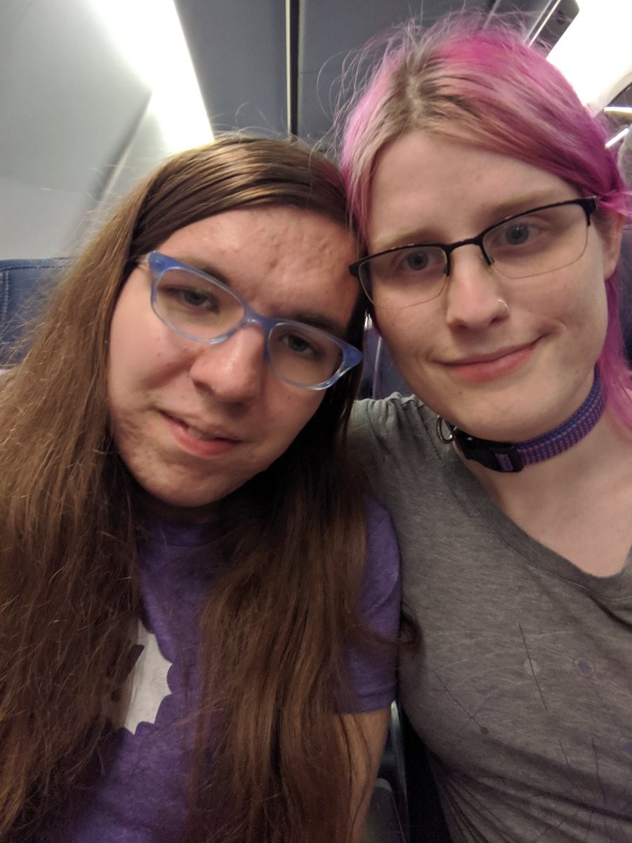 Two smiling women on a plane