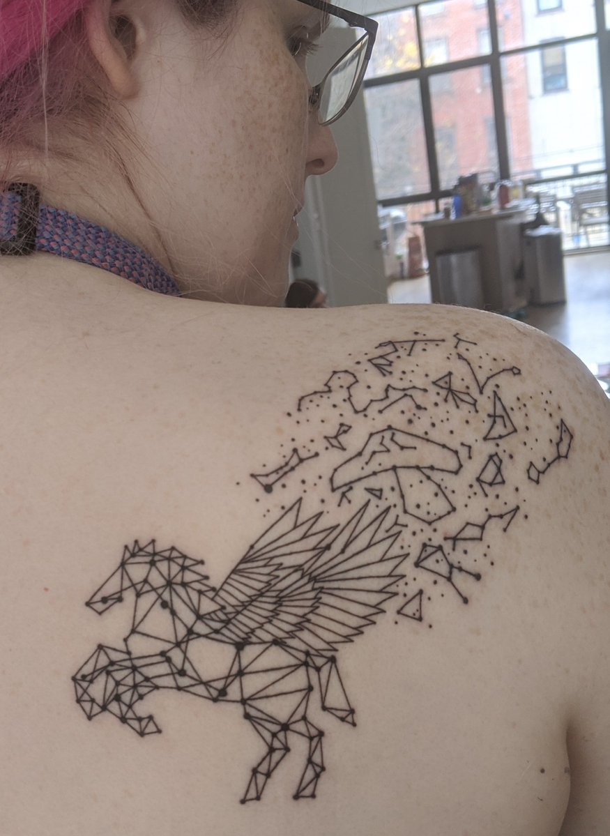 A tattoo on my right shoulder. A Pegasus drawn out of straight geometric shapes. Other constellations and stars are shown off the top of her wings