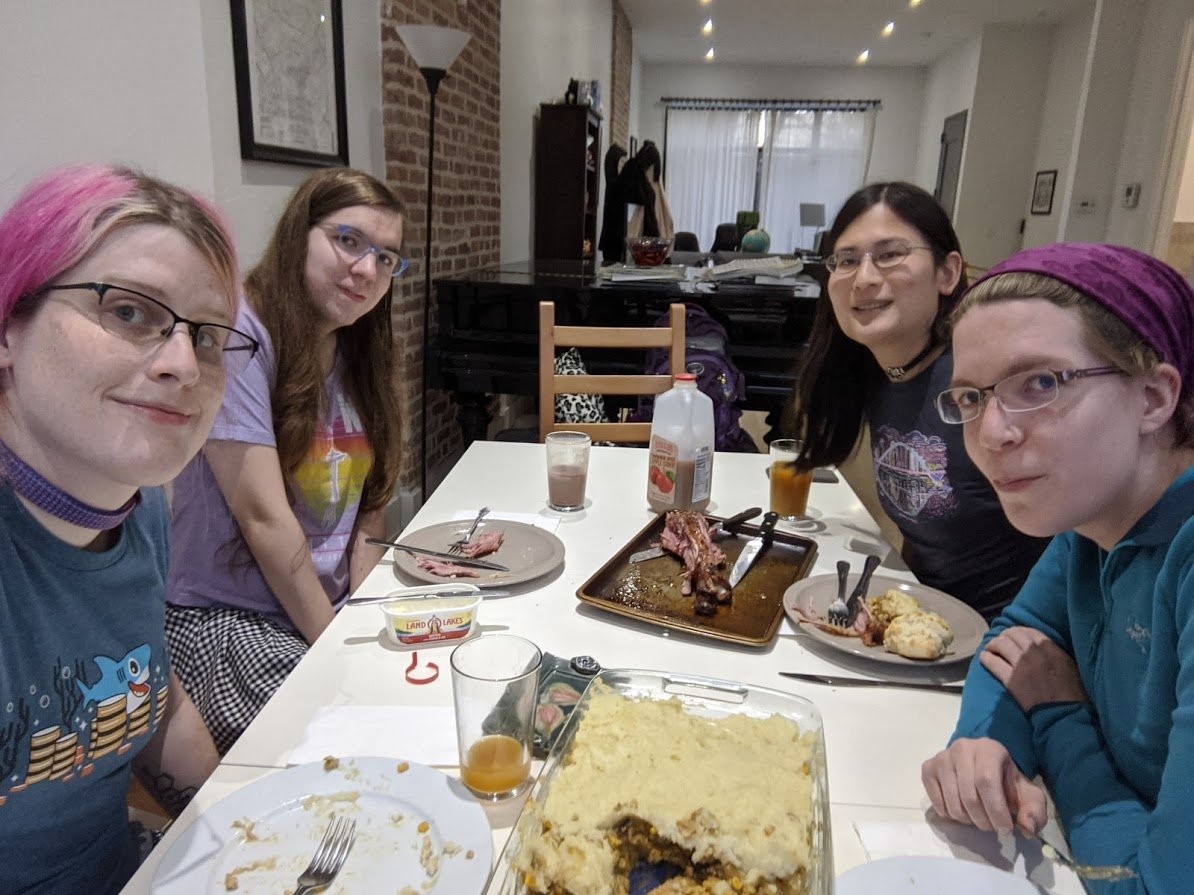 Myself, Natalie, Liz, and Elly seated around the set table