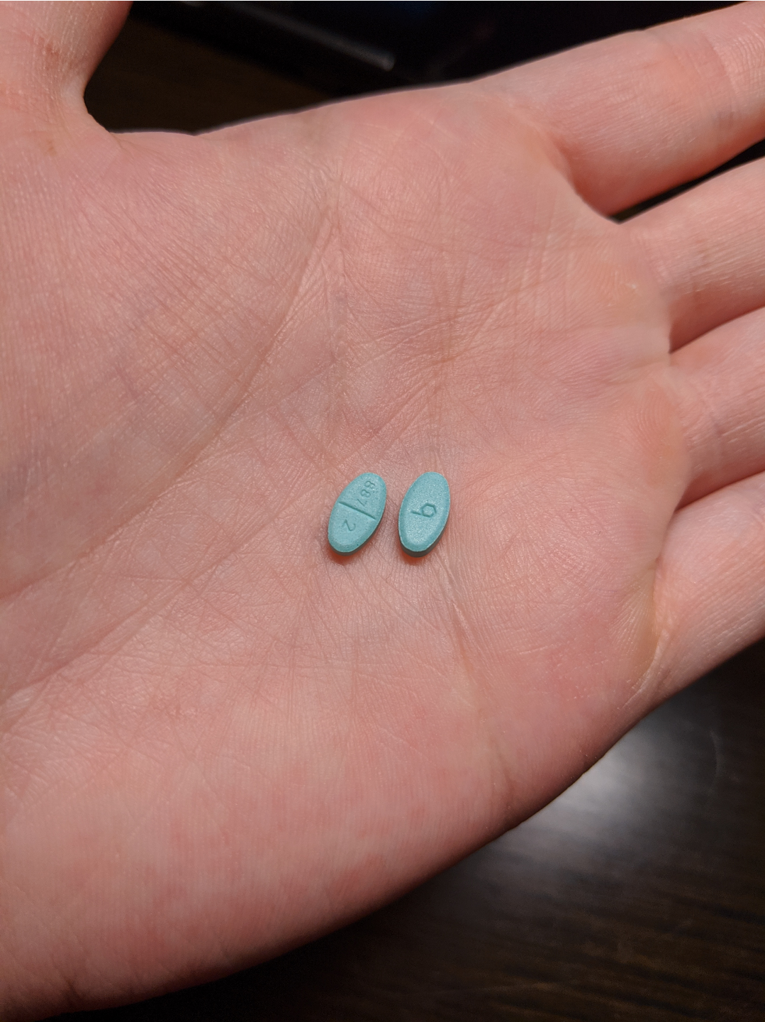 two oestrogen tablets in my hand