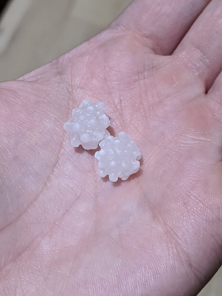 A handful of two balls of sugar with irregular bumps