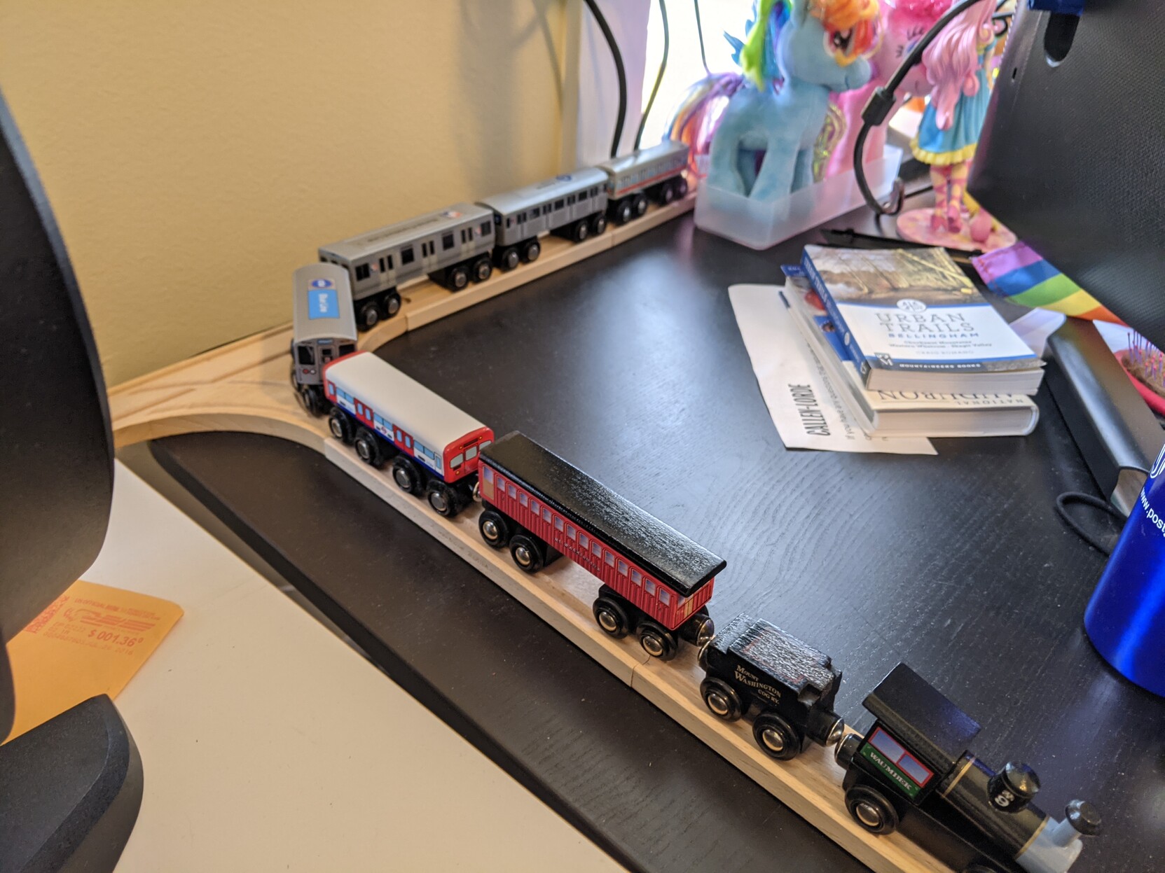 A trail of wooden trains from different transit systems