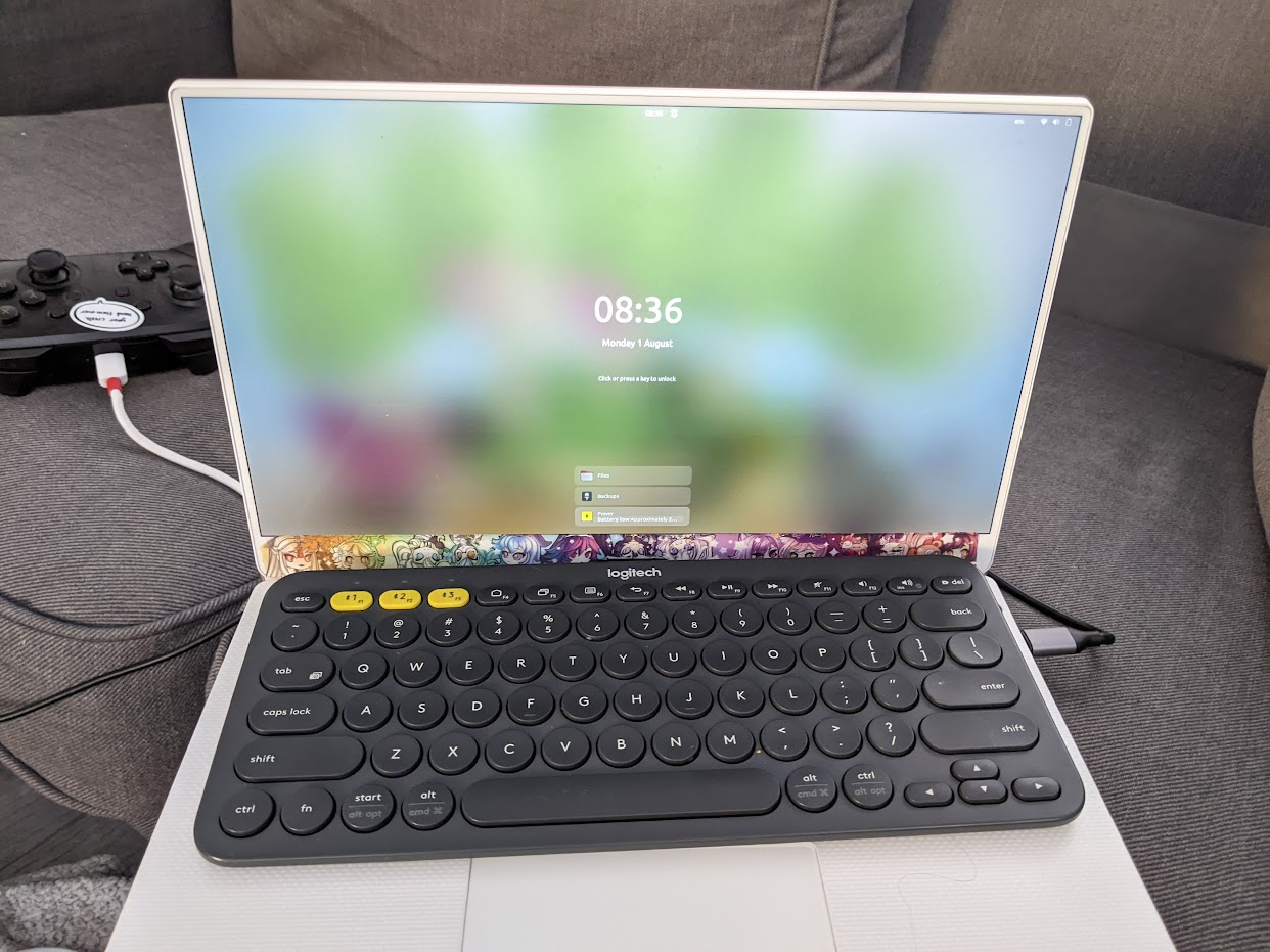a white laptop with a grey bluetooth keyboard on it