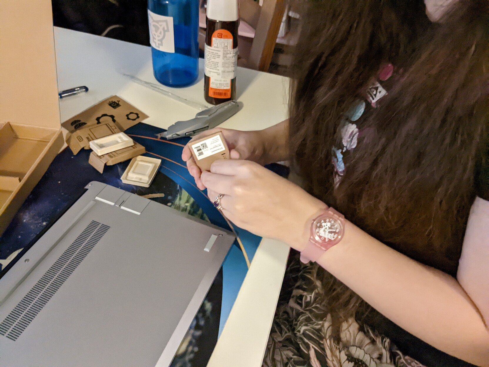 My wife opening a box with an expansion card, surrounded by expansion card packaging